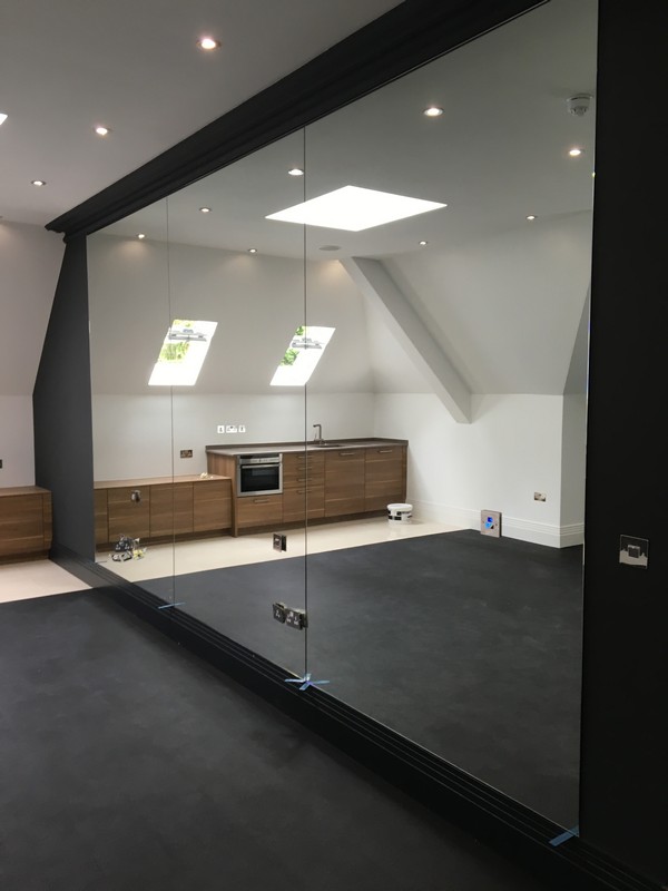 Frameless glass partition in loft conversion by Clapton glaziers